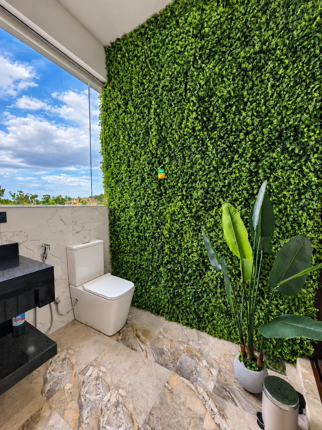 Bathroom interior with green feature wall and tropical styling